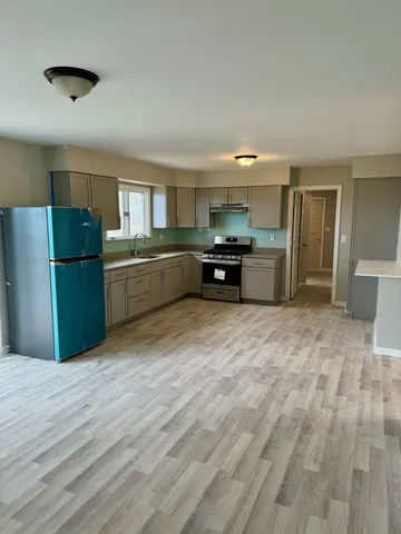 a kitchen with a refrigerator and a sink