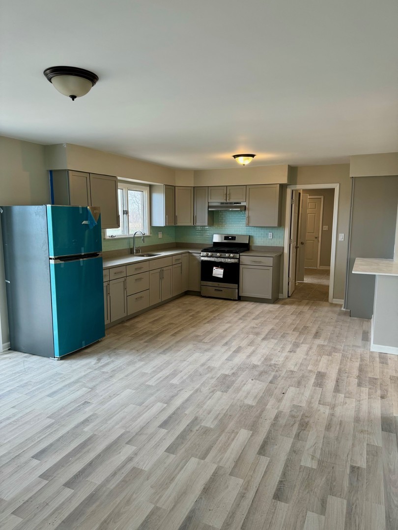 18708 Beck Road Marengo, IL 60152 - Photo 5 of 16 a kitchen with a refrigerator and a sink