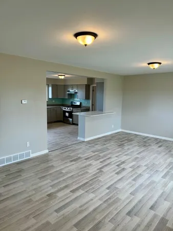 a view of a kitchen and dining room with wooden floor