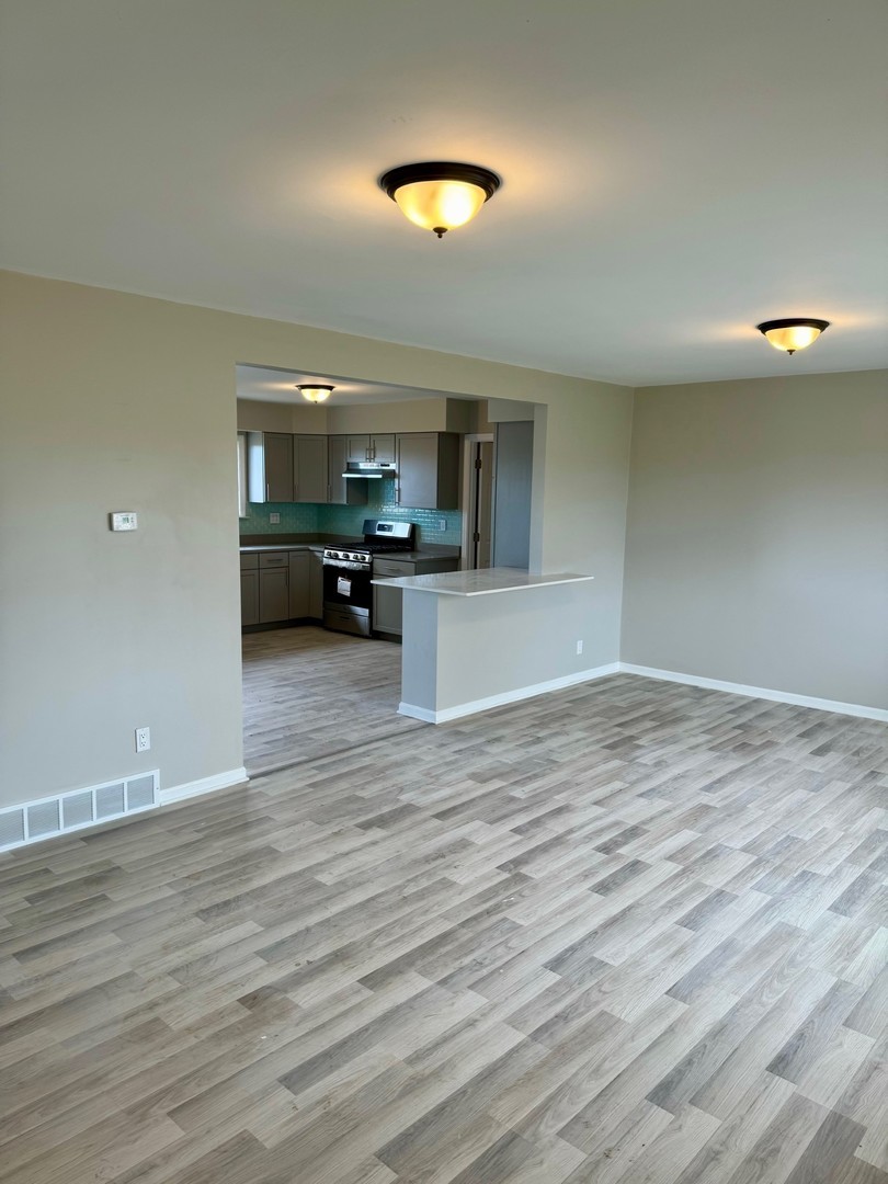 18708 Beck Road Marengo, IL 60152 - Photo 6 of 16 a view of a kitchen and dining room with wooden floor