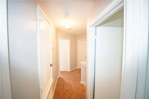 a view of a bathroom from a hallway