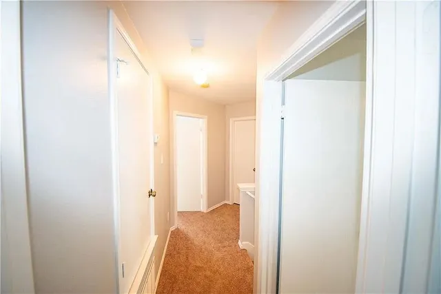 a view of a bathroom from a hallway