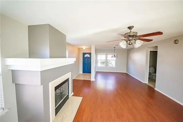a view of a kitchen with wooden floor and staircase