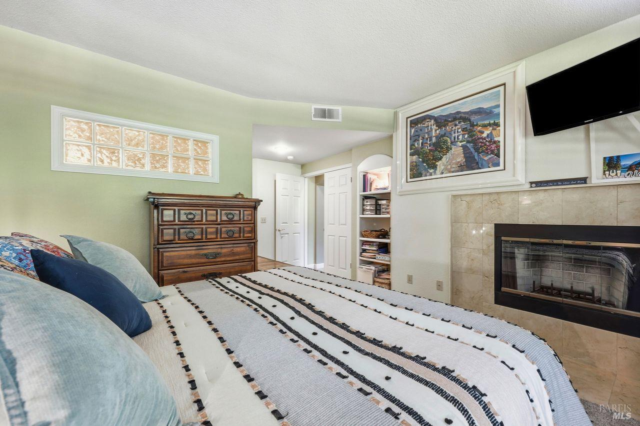 2092 Stonefield Lane Santa Rosa, CA 95403 - Photo 24 of 44 a bedroom with a bed and a flat screen tv