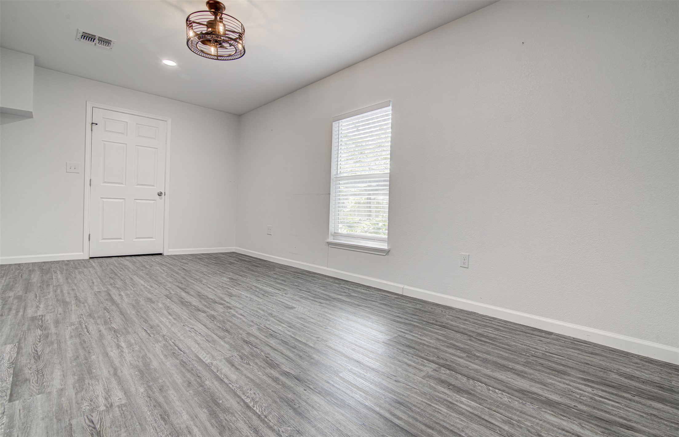 1807 San Jose Street Georgetown, TX 78626 - Photo 14 of 21 Well-lit room with durable wood flooring and ample natural light.
