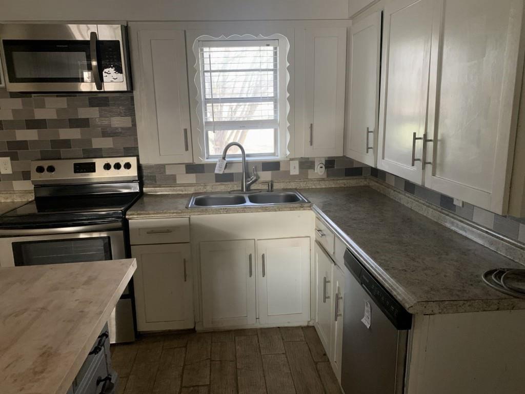 1210 Troy Road Wylie, TX 75098 - Photo 12 of 12 a kitchen with a sink stove and cabinets