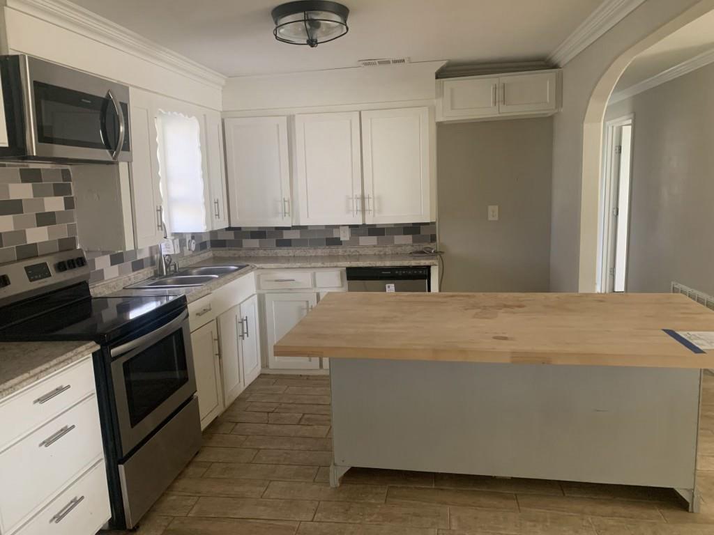 1210 Troy Road Wylie, TX 75098 - Photo 5 of 12 a kitchen with a sink stove and microwave
