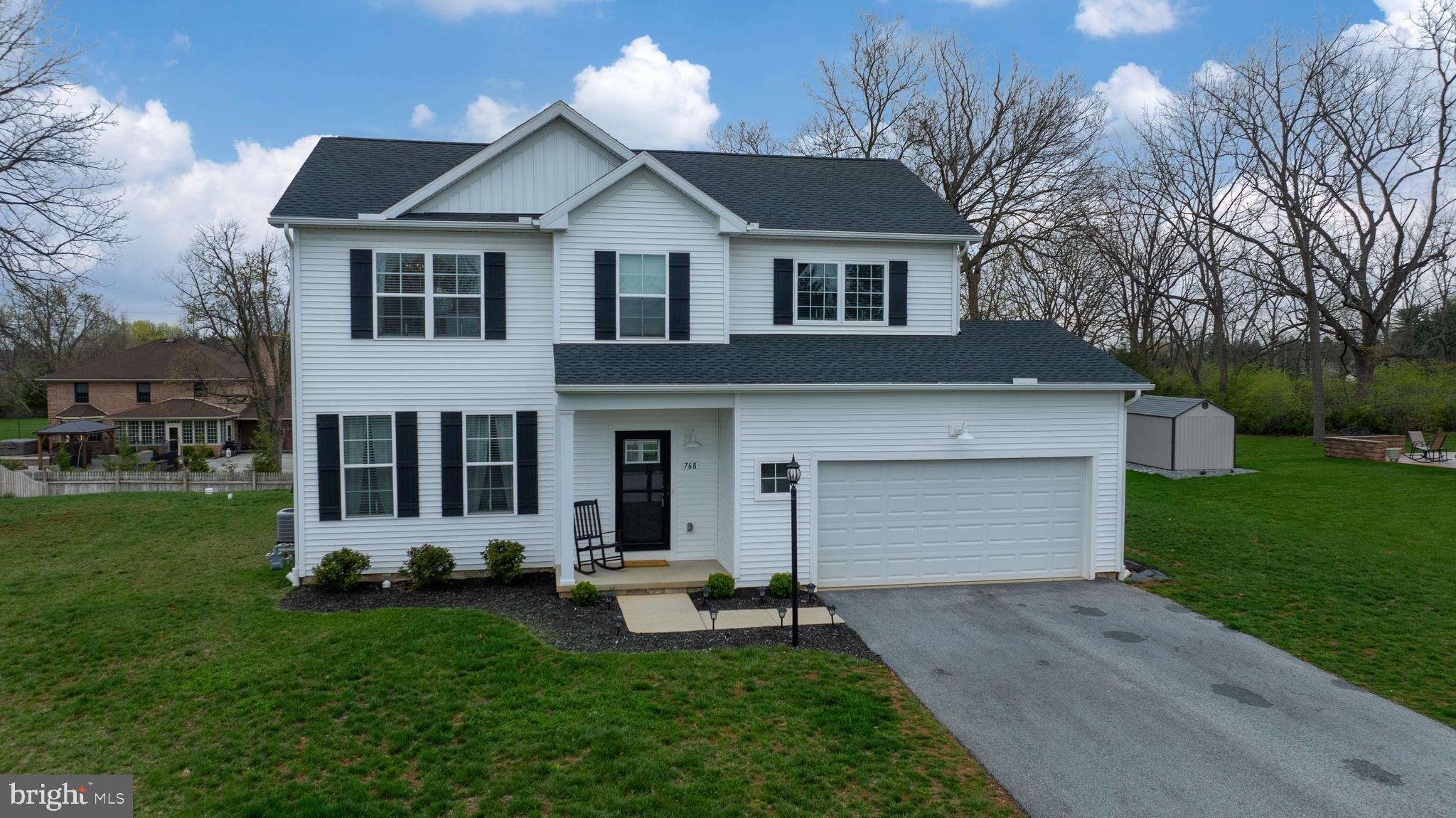 768 Weldon Drive York, PA 17404 - Photo 1 of 36 a front view of a house with a garden and trees