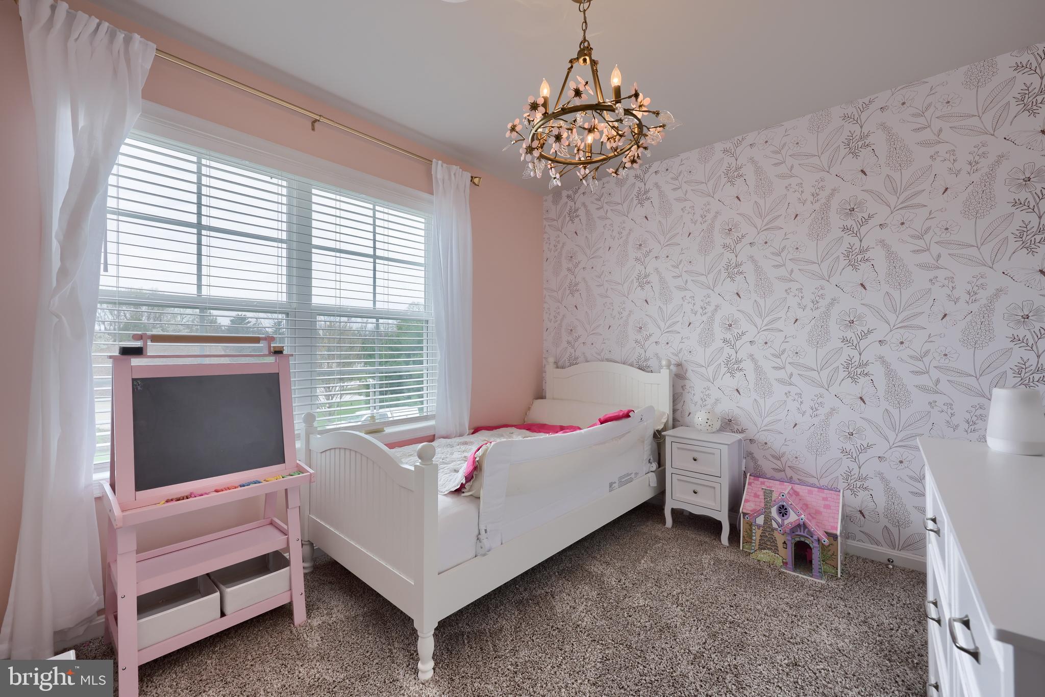 768 Weldon Drive York, PA 17404 - Photo 25 of 36 a bedroom with a bed and a chandelier