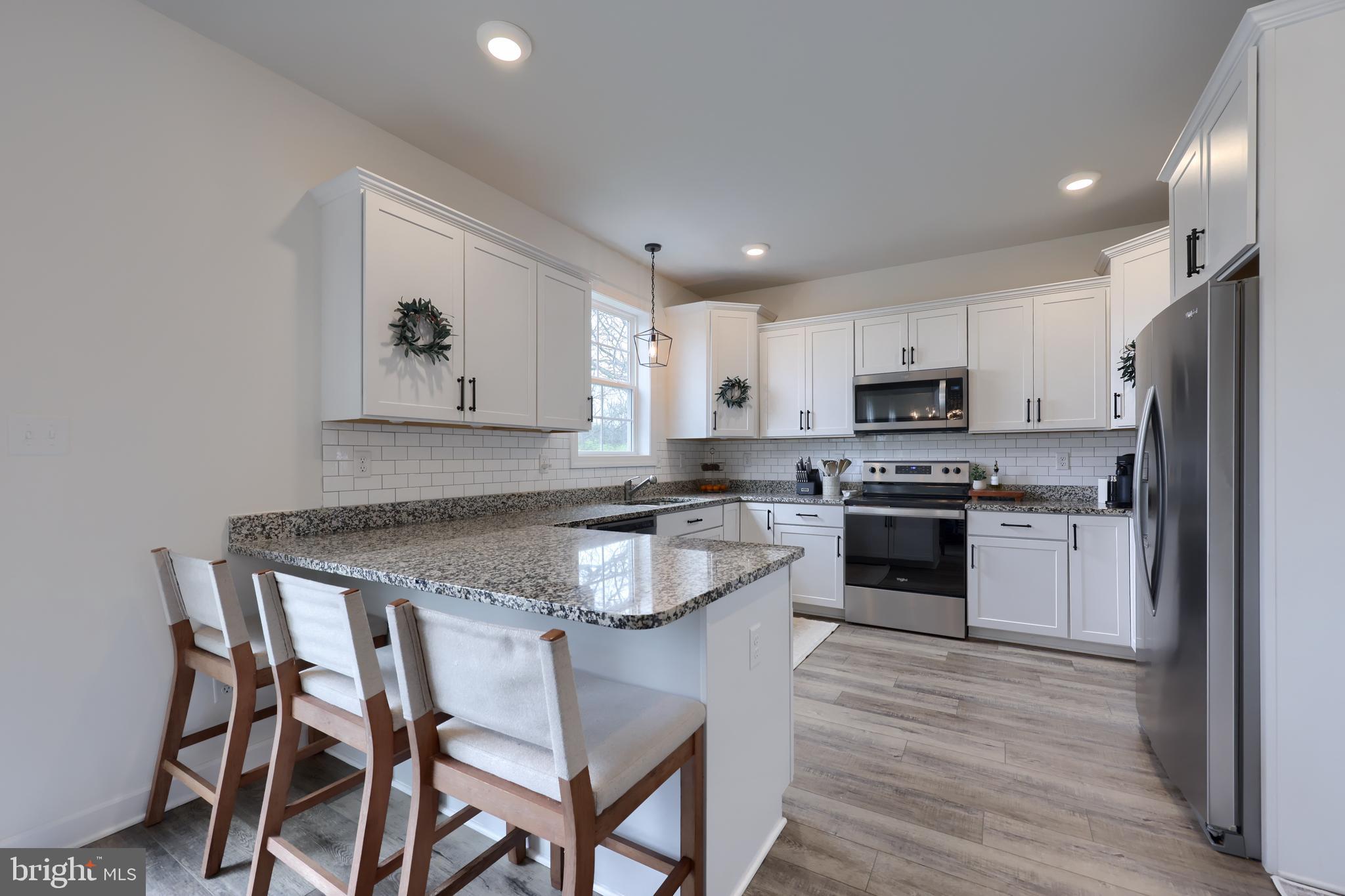 768 Weldon Drive York, PA 17404 - Photo 7 of 36 a kitchen with kitchen island white cabinets and stainless steel appliances