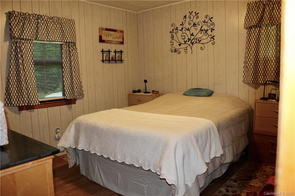 118 Cedar Tree Ln Mill Spring Mill Spring, NC 28756 - Photo 22 of 23 a bedroom with a bed and a window