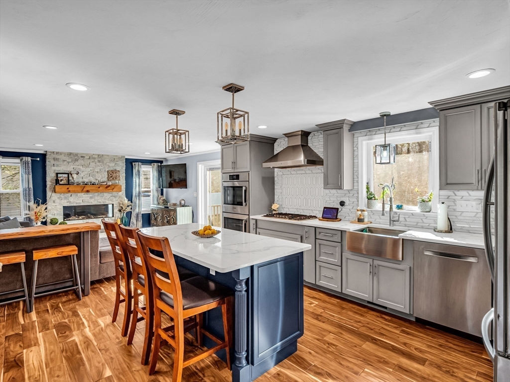 13 Blueberry Drive Acushnet, MA 02743 - Photo 2 of 36 a large kitchen with stainless steel appliances a table and chairs in it