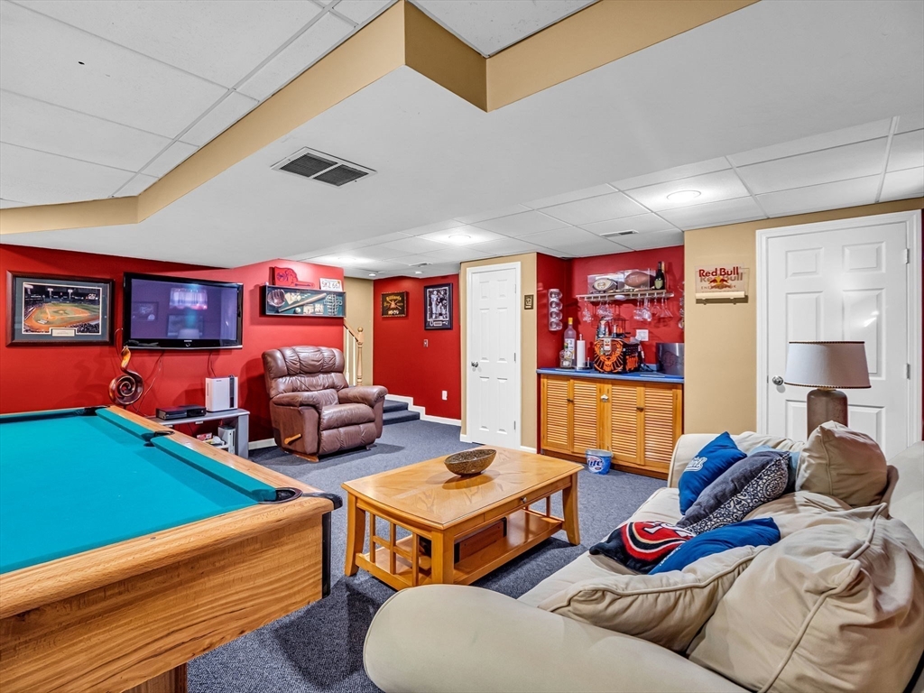 13 Blueberry Drive Acushnet, MA 02743 - Photo 26 of 36 a living room with furniture kitchen view and a flat screen tv