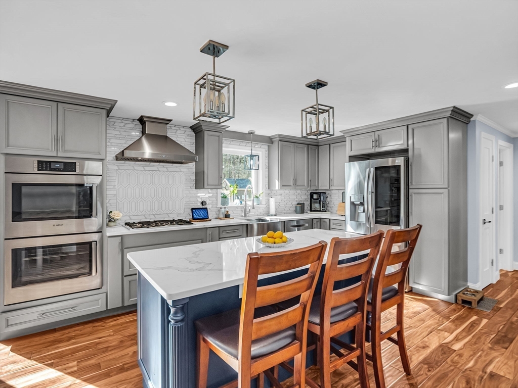 13 Blueberry Drive Acushnet, MA 02743 - Photo 4 of 36 a kitchen with a dining table chairs stainless steel appliances and cabinets