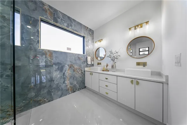 a bathroom with a double vanity sink and a mirror