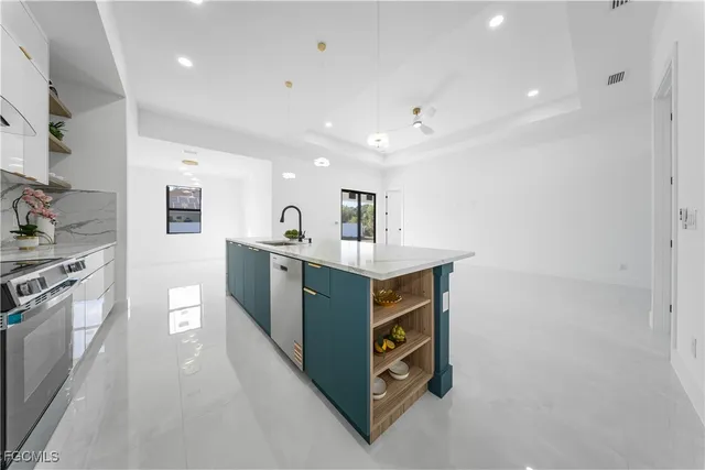 a kitchen with stainless steel appliances granite countertop a stove and a sink