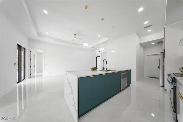 a kitchen with stainless steel appliances a sink stove and refrigerator