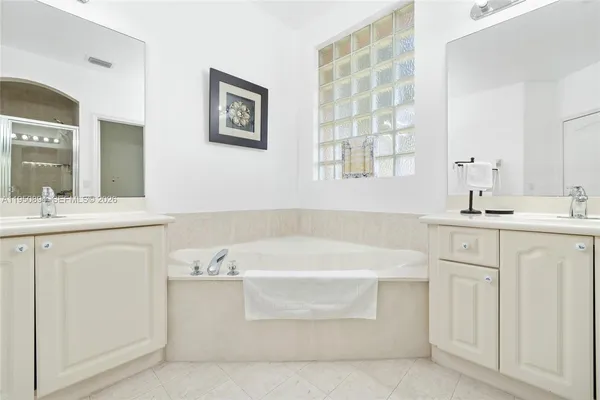 a bathroom with a bathtub sink and mirror