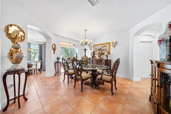a very nice looking open dining room with kitchen view and a large window