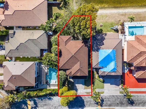 an aerial view of a houses with yard