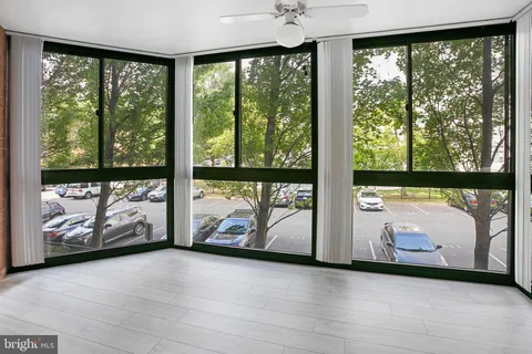 a view of an empty room with wooden floor and iron floor