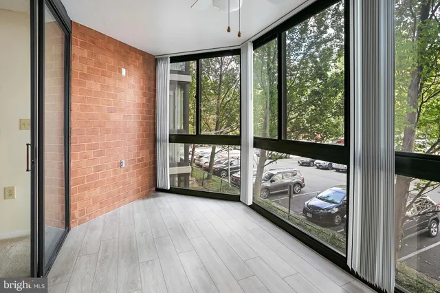 a view of a room with wooden floor and balcony