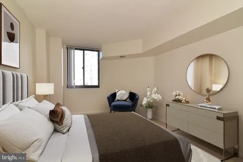 a bedroom with a bed and a mirror