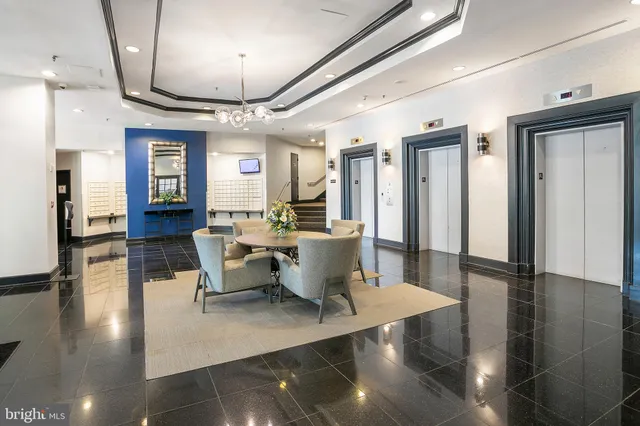 a view of a dining room with furniture a chandelier and wooden floor