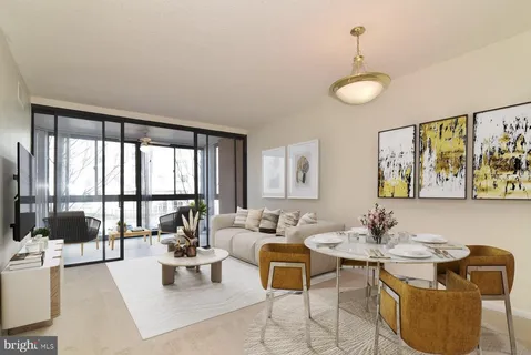 a living room with furniture and floor to ceiling window