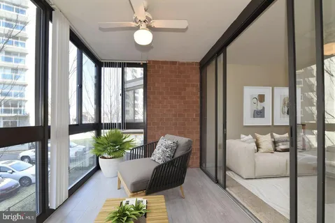 a living room with furniture and a potted plant