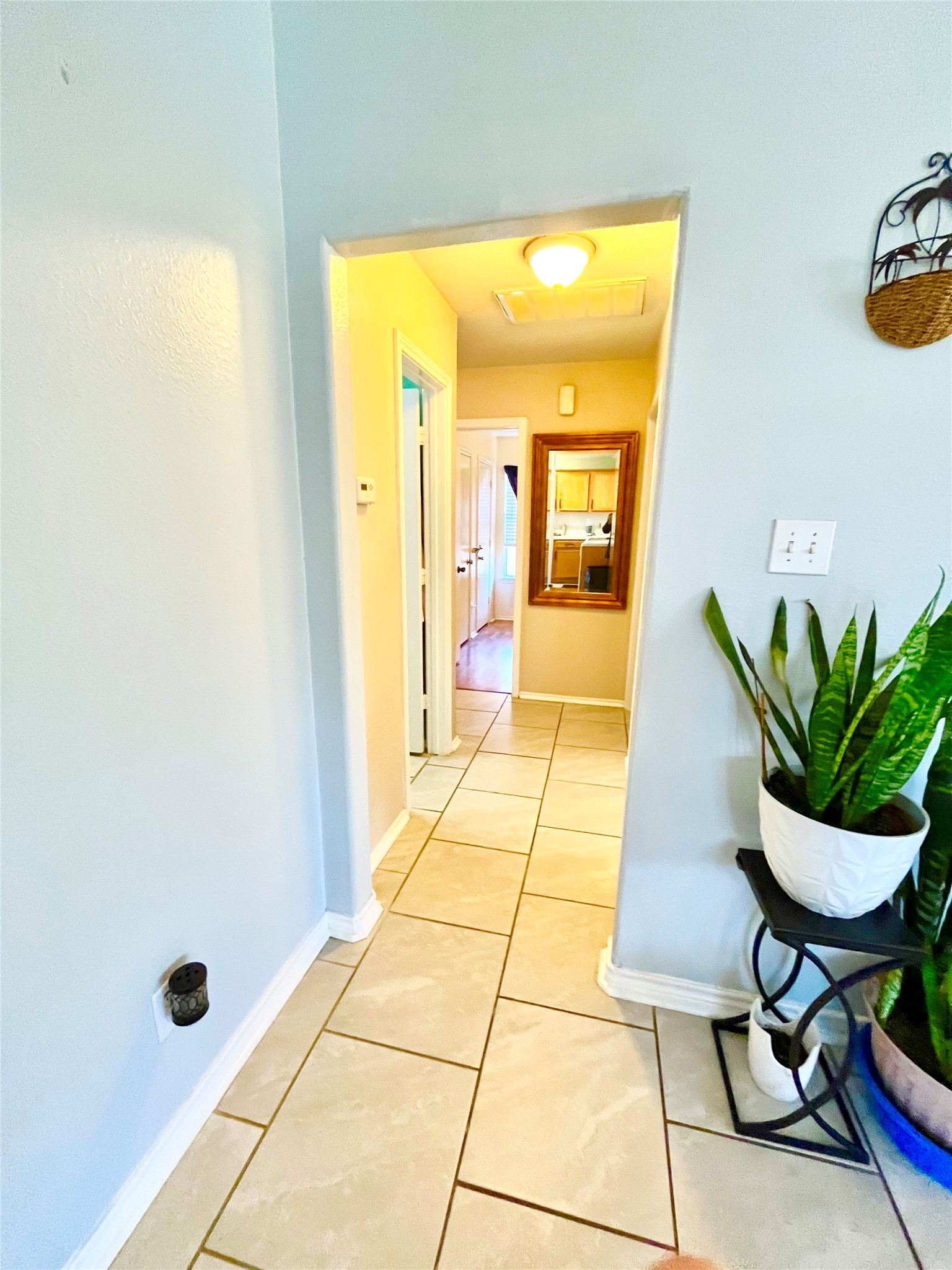 13139 Cutler Ridge Lane Houston, TX 77044 - Photo 7 of 10 a hallway with painting and a potted plant