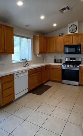 a kitchen with stainless steel appliances granite countertop a stove sink and cabinets