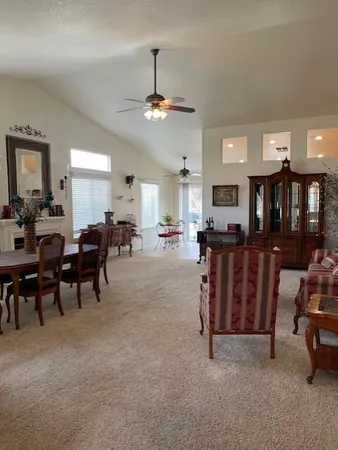 a view of a livingroom with furniture and a ceiling fan