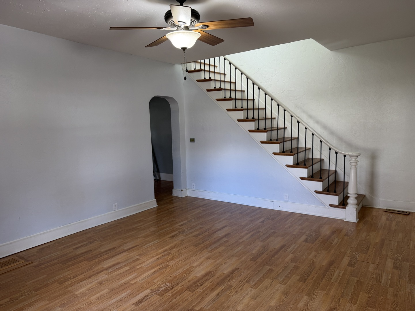 307 East Willow Street Normal, IL 61761 - Photo 2 of 10 a view of an empty room with wooden floor and fan