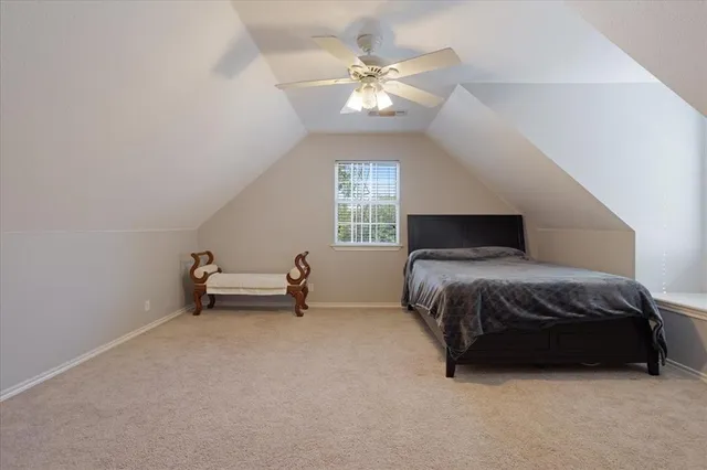 a spacious bedroom with a bed and a chandelier
