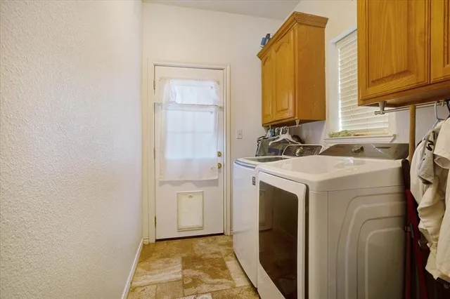 a utility room with a sink a washer and dryer