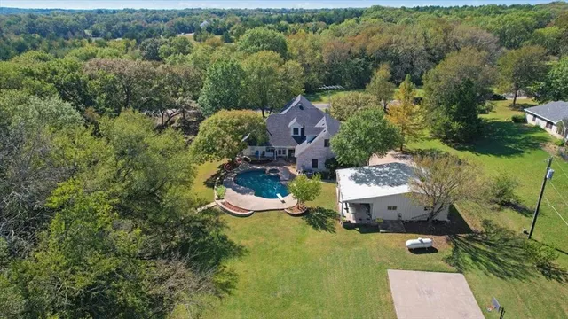 an aerial view of a house with a yard