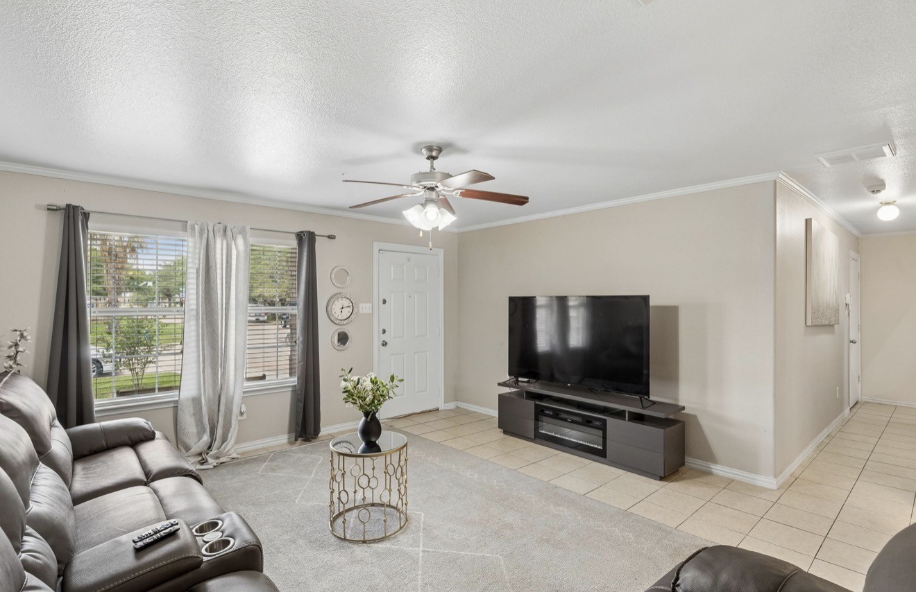 7118 Rising Brook Drive Cypress, TX 77433 - Photo 4 of 21 a living room with furniture a flat screen tv and a large window
