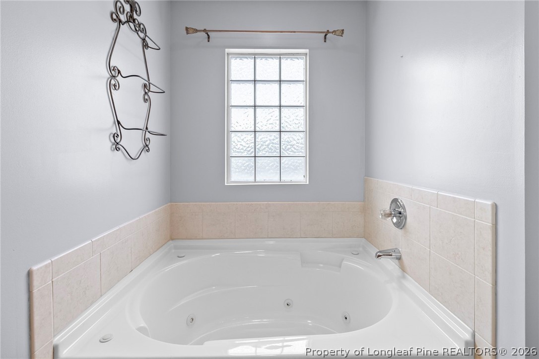 28 Coyt Circle Spring Lake, NC 28390 - Photo 22 of 41 a white bath tub sitting in a bathroom next to a window