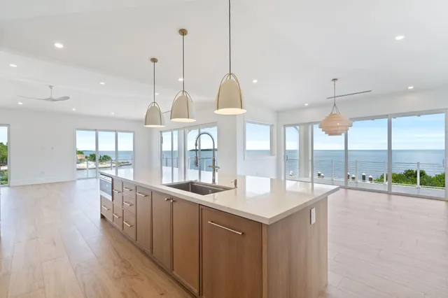 a kitchen with counter top space and wooden floor