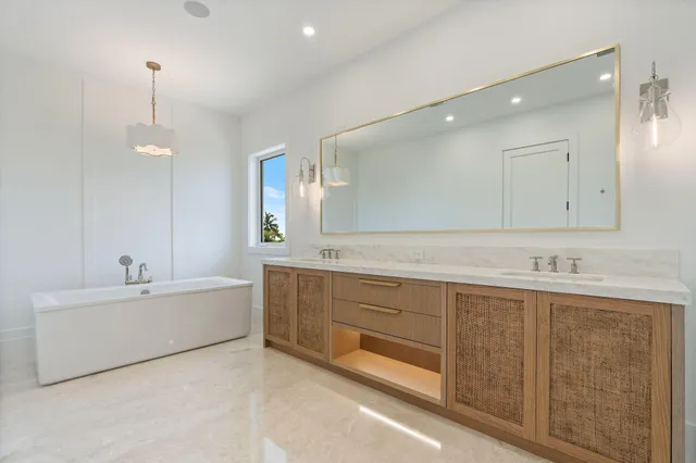 a bathroom with a tub sink shower and mirror
