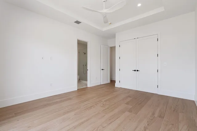 an empty room with wooden floor and a window