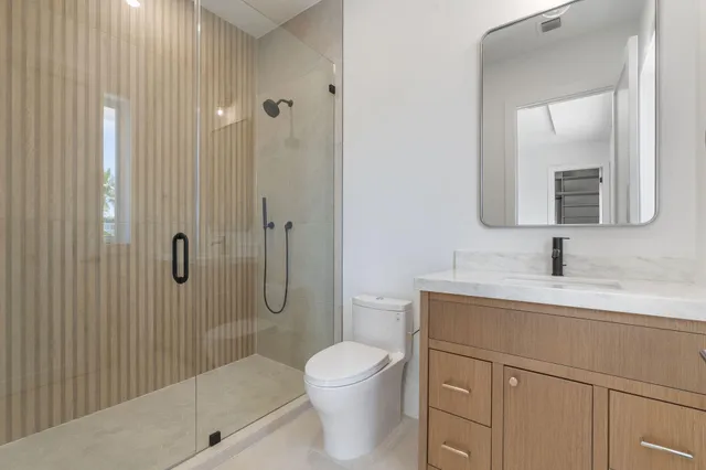 a kitchen with stainless steel appliances a sink a counter space and a view of living room