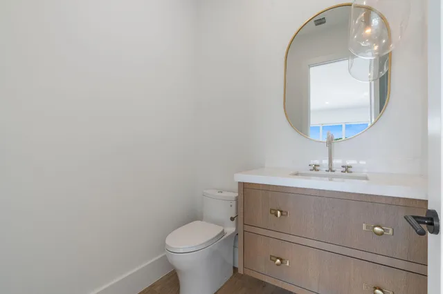 a large kitchen with stainless steel appliances kitchen island a large counter top and a wooden floors