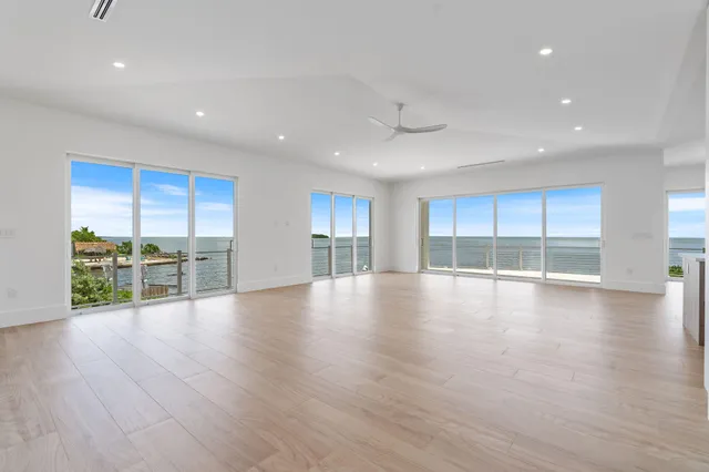 a large kitchen with a lot of counter space and wooden floor