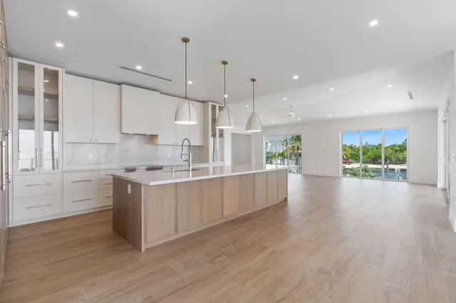 a view of a hallway with wooden floor and closet