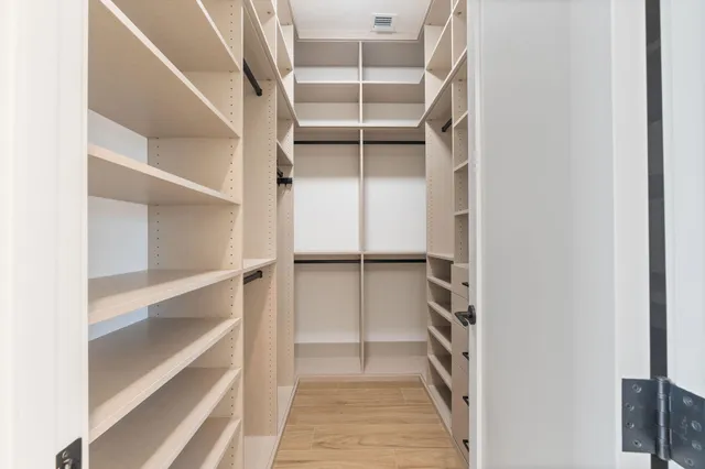 a spacious bathroom with a double vanity sink a mirror and a bathtub