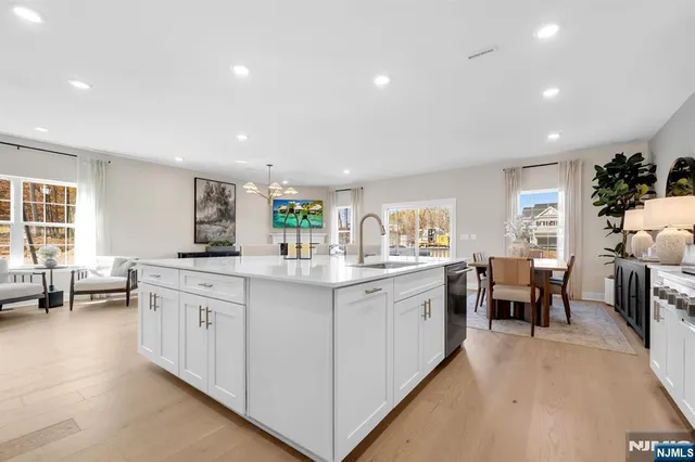 a kitchen with counter space sink stove and chairs