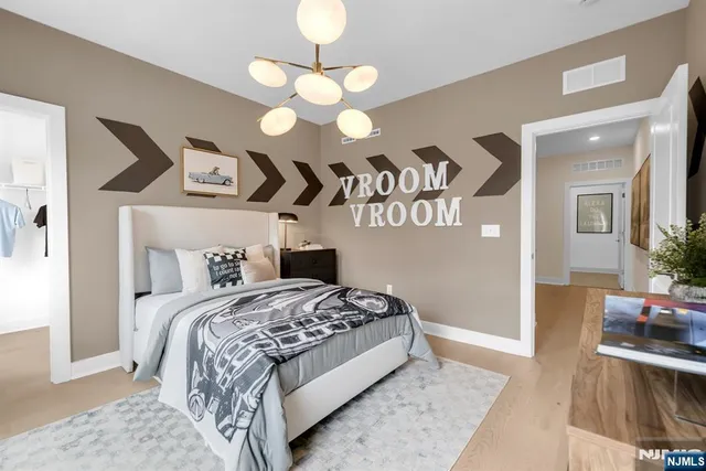 a bedroom with a bed and a chandelier