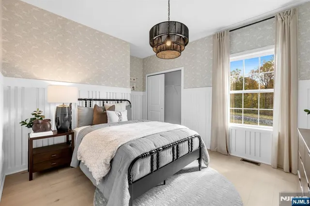 a bedroom with a bed and window